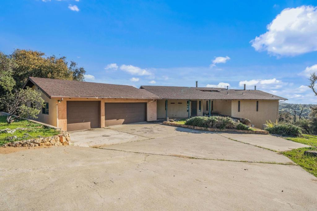 3252 Pine Hills Rd, Julian, CA 92036 - ranch-style home featuring concrete driveway, a garage, and stucco siding