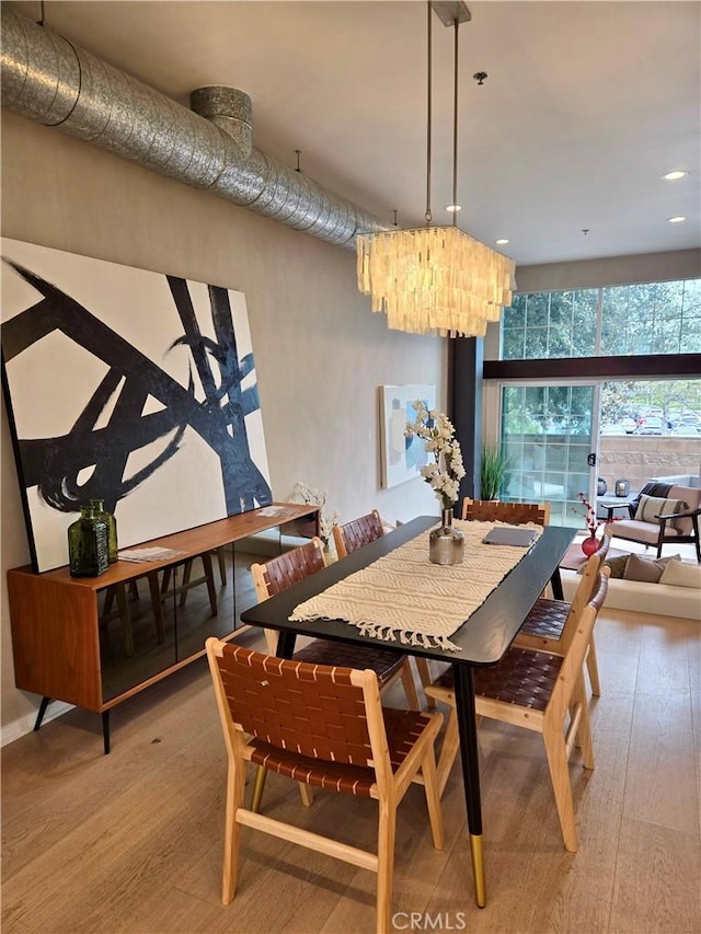 dining room featuring hardwood / wood-style flooring and recessed lighting
