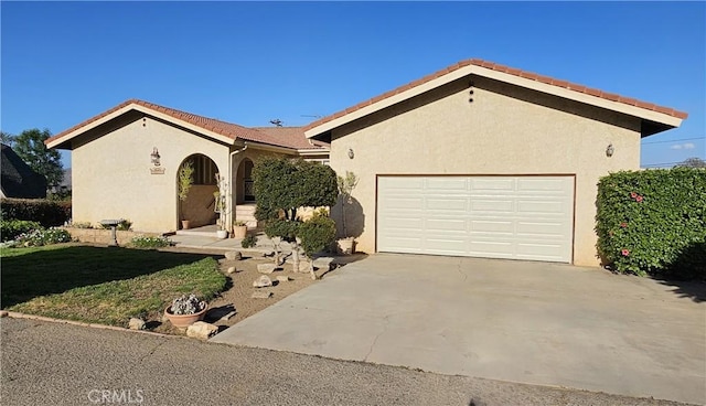 ranch-style house featuring stucco siding, driveway, and a garage