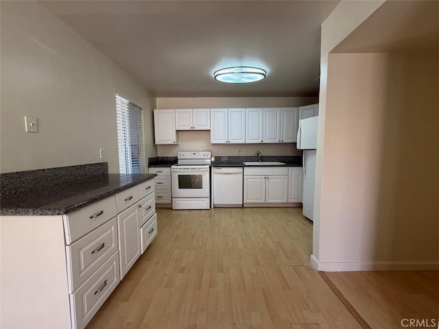 kitchen with white cabinetry, a sink, white appliances, and light wood-type flooring