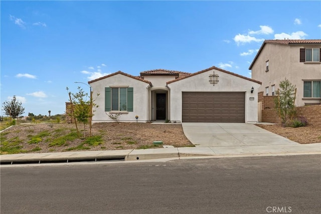 25441 Luna Peak Rd, Menifee, CA 92586 - mediterranean / spanish-style home featuring a garage, stucco siding, driveway, and a tile roof