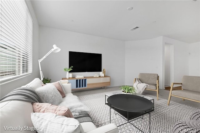 carpeted living area with visible vents