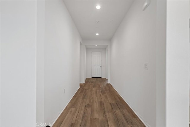 hall with baseboards, recessed lighting, and wood finished floors