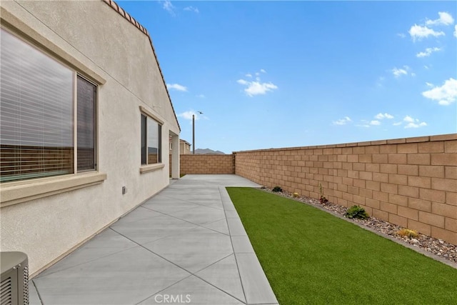 view of yard with a patio and a fenced backyard