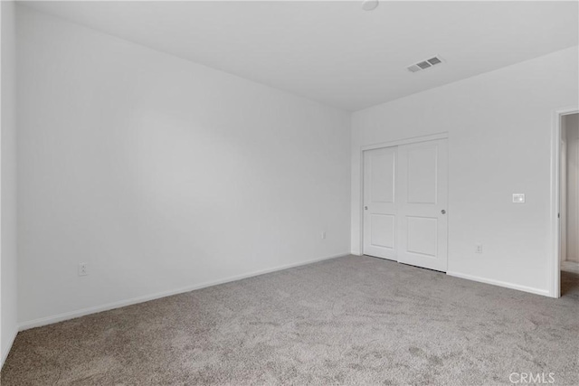 unfurnished bedroom featuring visible vents, carpet flooring, and baseboards