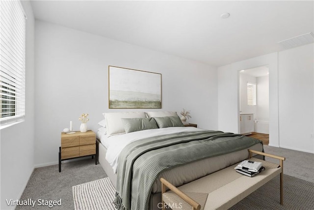 bedroom featuring visible vents, multiple windows, carpet floors, and baseboards