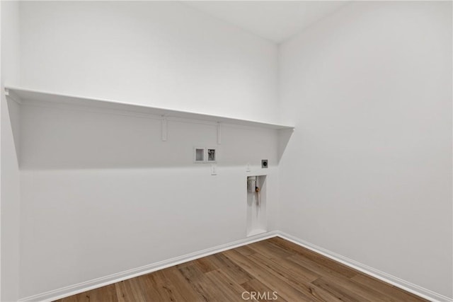 laundry area with hookup for a washing machine, wood finished floors, laundry area, hookup for an electric dryer, and baseboards