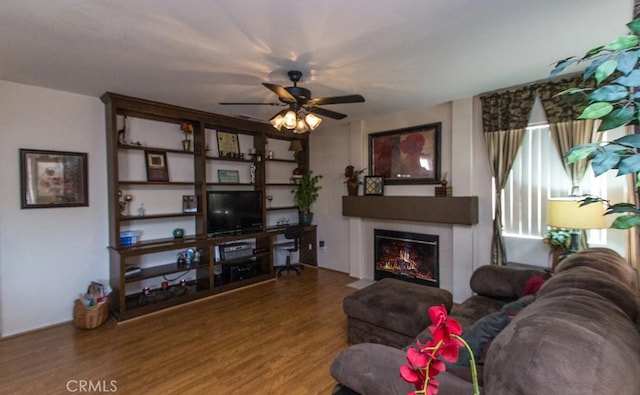 39675 Via Las Palmas, Murrieta, CA 92563 - living area with a glass covered fireplace, a ceiling fan, and wood finished floors