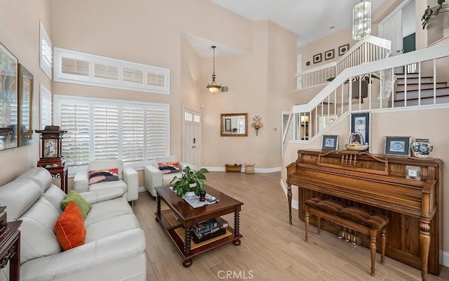 39675 Via Las Palmas, Murrieta, CA 92563 - living area featuring wood finished floors, a high ceiling, and stairway