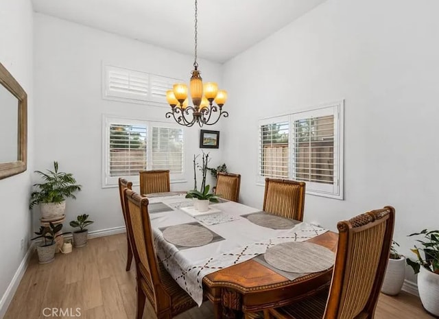 39675 Via Las Palmas, Murrieta, CA 92563 - dining room with light wood-style floors, baseboards, and a notable chandelier