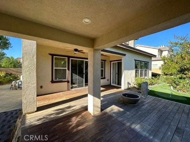 164 Newall, Irvine, CA 92618 - view of patio / terrace featuring an area to practice putting, a wooden deck, a ceiling fan, and a fire pit