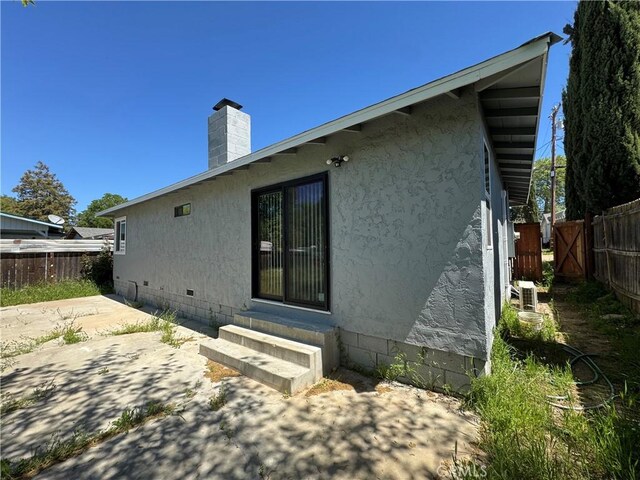 3723 Buckeye St, Clearlake, CA 95422 - back of property with a chimney, fence, entry steps, crawl space, and a patio