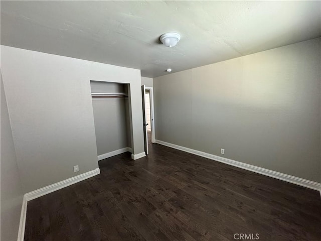 3723 Buckeye St, Clearlake, CA 95422 - unfurnished bedroom featuring baseboards, dark wood-type flooring, and a closet