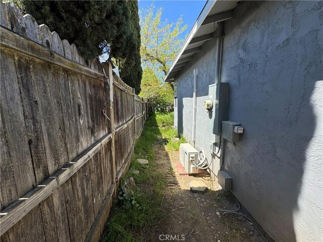 3723 Buckeye St, Clearlake, CA 95422 - view of side of home with fence, ac unit, and stucco siding