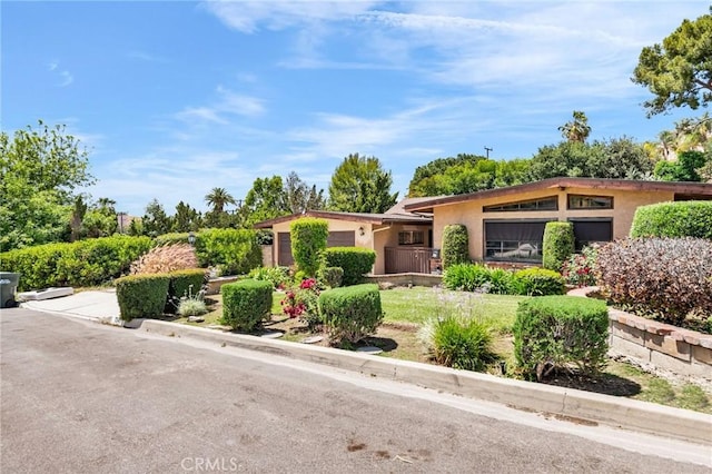 1341 E Harvest Moon St, West Covina, CA 91792 - view of front of house with stucco siding and an attached garage