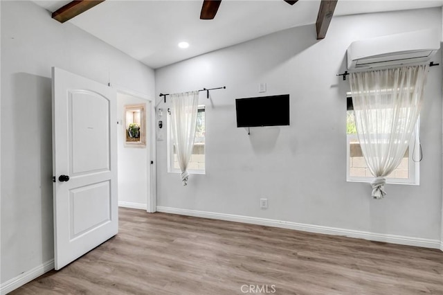 1341 E Harvest Moon St, West Covina, CA 91792 - unfurnished bedroom with beamed ceiling, baseboards, wood finished floors, a wall mounted AC, and a ceiling fan