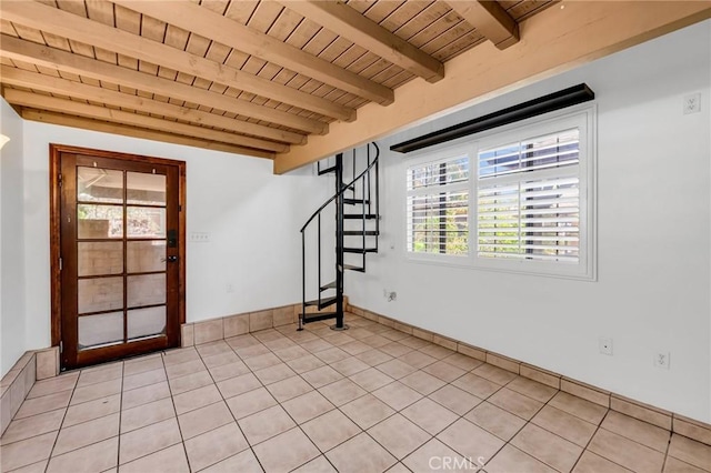 1341 E Harvest Moon St, West Covina, CA 91792 - spare room with wood ceiling with exposed beams, stairs, light tile patterned floors, and baseboards