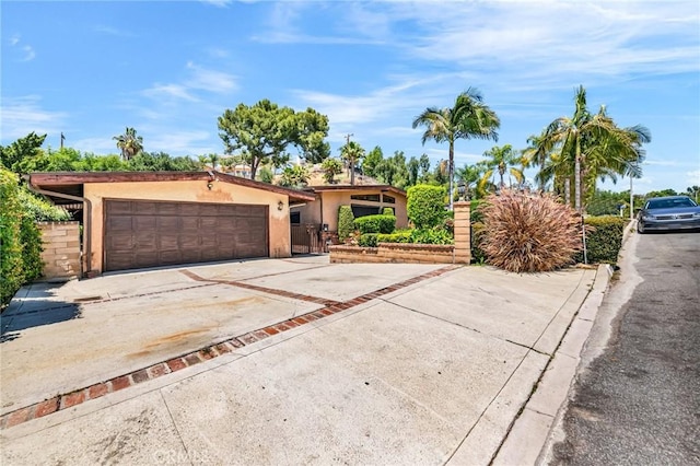 1341 E Harvest Moon St, West Covina, CA 91792 - view of front of house with concrete driveway, an attached garage, and stucco siding