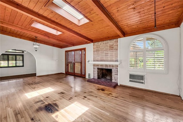 1341 E Harvest Moon St, West Covina, CA 91792 - unfurnished living room with wooden ceiling, a skylight, a fireplace, wood finished floors, and baseboards
