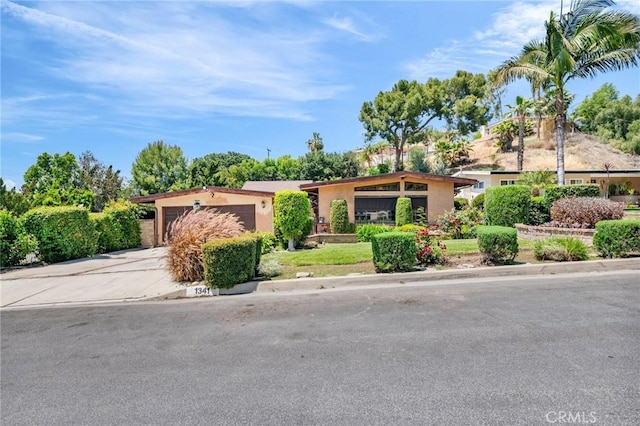 1341 E Harvest Moon St, West Covina, CA 91792 - view of front of home featuring driveway, stucco siding, and an attached garage