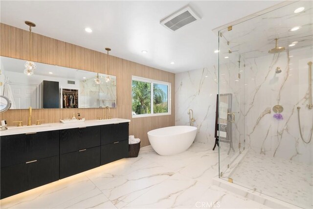 full bathroom with a marble finish shower, a sink, visible vents, a freestanding tub, and marble finish floor