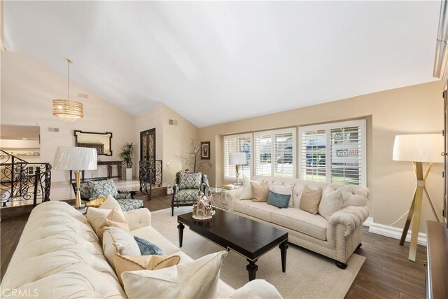 living room featuring high vaulted ceiling, visible vents, baseboards, and dark wood-style flooring