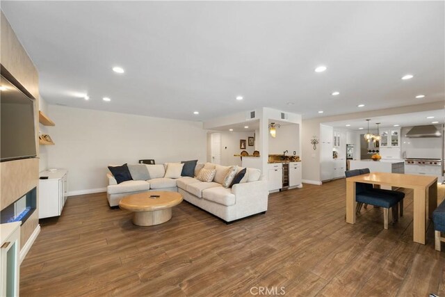 11030 Cozycroft Ave, Chatsworth, CA 91311 - living room featuring dark wood-style flooring, baseboards, recessed lighting, and wine cooler