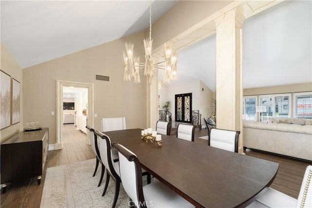 11030 Cozycroft Ave, Chatsworth, CA 91311 - dining area featuring wood finished floors, a chandelier, and high vaulted ceiling