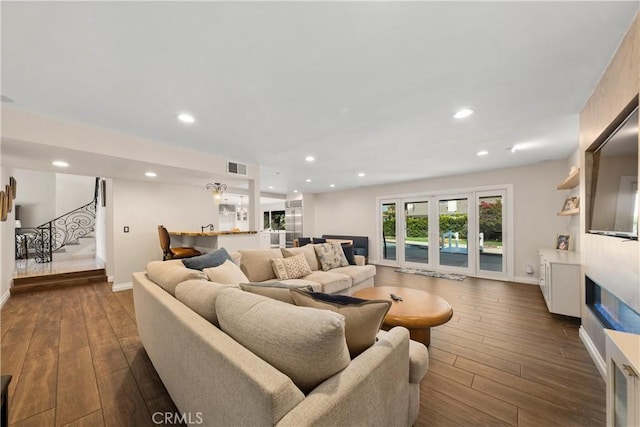 11030 Cozycroft Ave, Chatsworth, CA 91311 - living room with stairs, dark wood-type flooring, baseboards, recessed lighting, and a glass covered fireplace