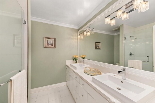 full bathroom featuring tile patterned flooring, a shower stall, a sink, and a chandelier