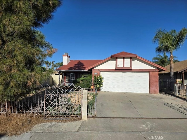 ranch-style house featuring concrete driveway, an attached garage, and fence