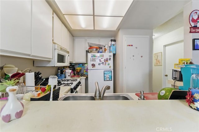1010 Margarita Dr Unit B201, Corona, CA 92879 - kitchen with white cabinetry, white appliances, light countertops, and a sink