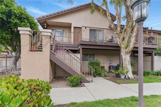1010 Margarita Dr Unit B201, Corona, CA 92879 - view of property with fence, central AC, and stairs