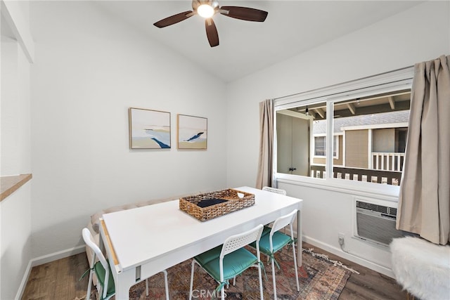 dining area featuring a wall mounted air conditioner, a ceiling fan, baseboards, wood finished floors, and vaulted ceiling