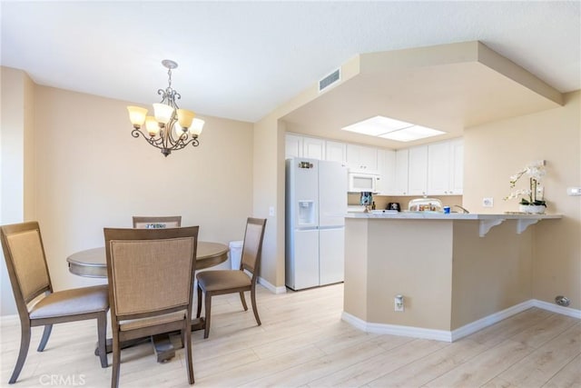 24352 Berrendo Unit 4, Aliso Viejo, CA 92656 - dining room featuring a chandelier, light wood finished floors, and baseboards