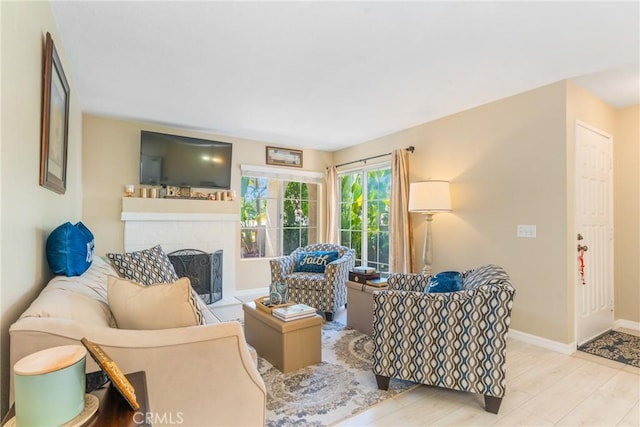 24352 Berrendo Unit 4, Aliso Viejo, CA 92656 - living room featuring baseboards, a fireplace, and wood finished floors
