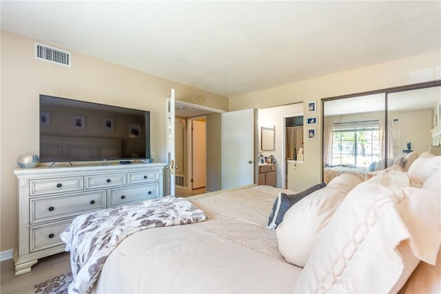 bedroom featuring baseboards and visible vents