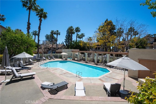 pool with a patio and fence