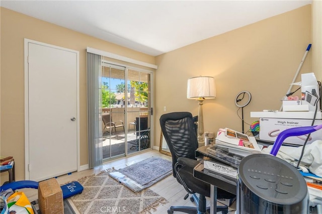 office area featuring baseboards and wood finished floors