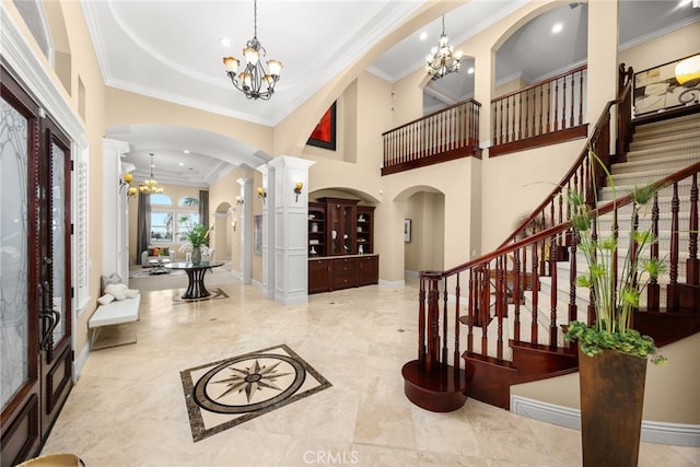 15841 Aurora Crest Dr, Whittier, CA 90605 - foyer featuring a chandelier, arched walkways, decorative columns, ornamental molding, and a high ceiling