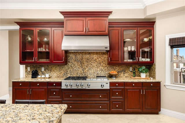 15841 Aurora Crest Dr, Whittier, CA 90605 - kitchen with exhaust hood, stainless steel gas cooktop, reddish brown cabinets, baseboards, and backsplash