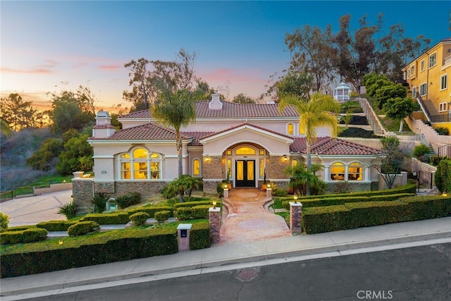 15841 Aurora Crest Dr, Whittier, CA 90605 - mediterranean / spanish-style house with french doors, a tiled roof, stucco siding, a chimney, and stone siding