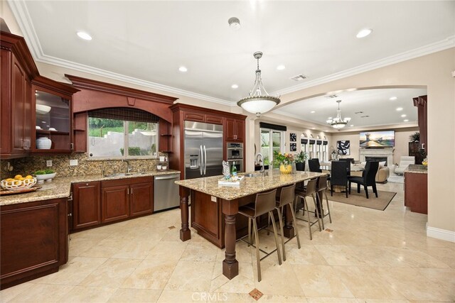 15841 Aurora Crest Dr, Whittier, CA 90605 - kitchen with stainless steel appliances, arched walkways, a sink, decorative backsplash, and glass insert cabinets