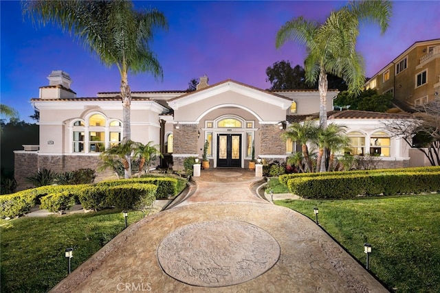 15841 Aurora Crest Dr, Whittier, CA 90605 - mediterranean / spanish-style house featuring french doors, stucco siding, stone siding, and a chimney