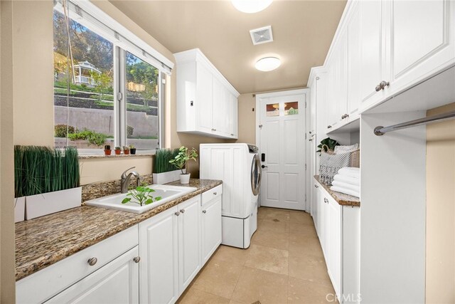 15841 Aurora Crest Dr, Whittier, CA 90605 - laundry room with washer / clothes dryer, cabinet space, and light tile patterned floors