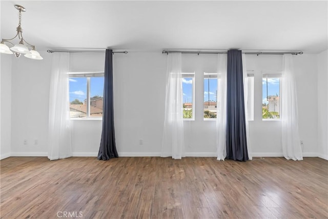 247 W 223rd St Unit D, Carson, CA 90745 - unfurnished room featuring healthy amount of natural light, wood finished floors, and baseboards