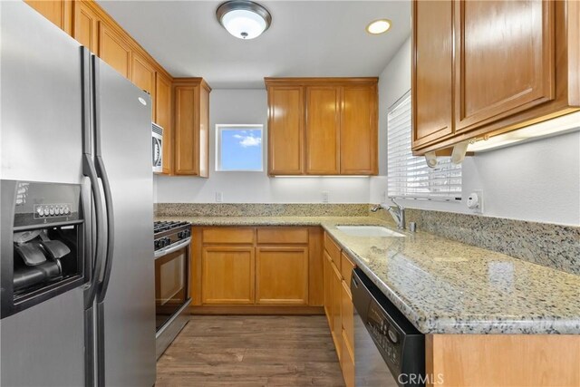 247 W 223rd St Unit D, Carson, CA 90745 - kitchen featuring appliances with stainless steel finishes, a sink, dark wood-style flooring, light stone counters, and recessed lighting