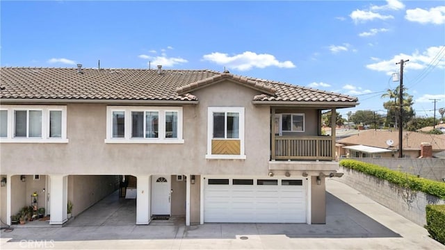 247 W 223rd St Unit D, Carson, CA 90745 - view of front of house featuring stucco siding, an attached garage, a tiled roof, fence, and driveway