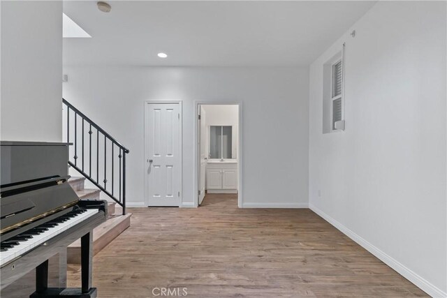 247 W 223rd St Unit D, Carson, CA 90745 - entrance foyer featuring light wood-style flooring, baseboards, stairs, and recessed lighting