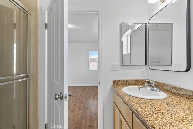 247 W 223rd St Unit D, Carson, CA 90745 - full bath with wood finished floors, a shower stall, vanity, and baseboards